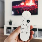 person holding white remote control